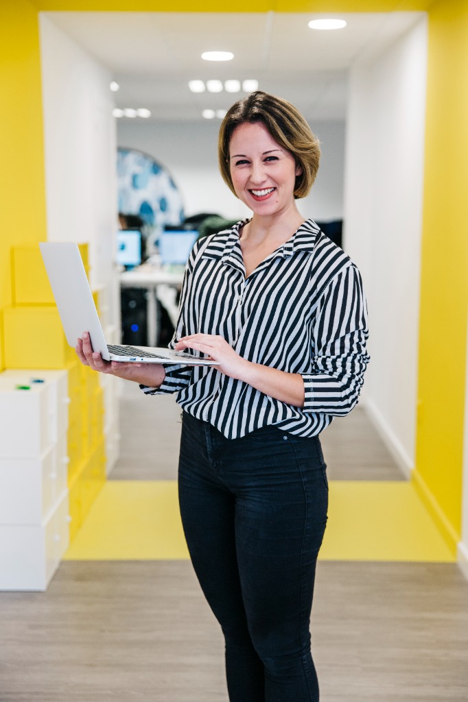 Female Executive Marketing Director Holding Laptop in Studio